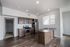 Modern kitchen with elegant cabinetry, stainless steel appliances, and a spacious island, enhanced by ample natural light and stylish hardwood floors.