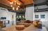 Modern living space with a sleek sectional sofa, elegant chandelier, and stylish decor in a contemporary setting.