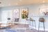 Elegant and modern living space with stylish bar stools, cozy seating, and vibrant floral artwork on the walls, perfect for entertaining.