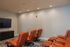 Inviting home theater with plush leather seating and a sleek mounted TV, perfect for cozy movie nights.