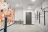 Modern bike storage room with vibrant geometric wall art, sleek bike racks, and minimalist design.