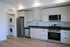 Modern kitchen with sleek cabinetry, stainless steel appliances, and an in-unit washer and dryer, perfect for convenient living.
