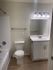 Bright, modern bathroom with sleek fixtures, spacious vanity, and contemporary lighting.