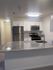 Modern kitchen with sleek stainless steel appliances, elegant granite countertops, and stylish white cabinetry, offering a perfect blend of functionality and contemporary design.