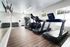 Modern fitness center with sleek treadmills, extensive free weights, and bright natural lighting.