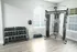 Modern gym space with sleek fitness equipment and a range of dumbbells, perfect for an active lifestyle.