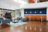 Modern lounge area with cozy armchairs, sleek tables, and a vibrant orange and blue color scheme, perfect for relaxation and socializing.