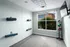 Modern fitness room with yoga mats, exercise balls, and a bright window view.