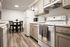 Modern kitchen with elegant cabinetry, sleek appliances, and stylish dining area, exuding a cozy and inviting atmosphere.