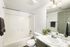 Modern bathroom with elegant marble countertop, sleek fixtures, and refreshing greenery enhancing the serene ambiance.
