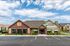 Charming community center at The Meadows at Wicklow, featuring classic brick architecture and inviting landscaping under a bright blue sky.