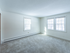 Multiple windows and carpeting in living area in an apartment at Princeton at Mill Pond | Dover New Hampshire Apartments
