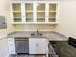 Prepare meals and entertain guests in our community kitchen featuring appliances, prep space, and dining areas. Cooking made convenient.  | Princeton on Beacon Street | Princeton on Beacon Street Apartments