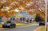 An autumn street view of the brick exterior at Princeton Commons Princeton Commons | Apartment in Claremont, NH