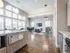 Open concept living area with wood plank style floor and stainless steel appliances | Apartments For Rent In Chelmsford MA | Mill and 3 Apartments