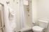 This primary bedroom with attached bath offers convenient privacy and comfort with ensuite bathroom access. | 381 Congress Lofts | Apartment in, Boston MA