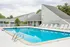 Dive into relaxation in our sparkling swimming pool surrounded by premium deck furniture and refreshing shade structures. | Foreside Estates | Foreside Estates Apartments