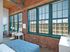 This elegant primary bedroom features sophisticated design elements and comfortable proportions for restful nights.  | Watch Factory Lofts | Watch Factory Lofts Apartments