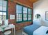 This elegant primary bedroom features sophisticated design elements and comfortable proportions for restful nights. | Watch Factory Lofts | Watch Factory Lofts Apartments