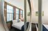 A light-filled bedroom features an open layout and contemporary details, creating an airy atmosphere for ultimate relaxation. | Watch Factory Lofts | Watch Factory Lofts Apartments