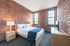 The primary bedroom with walk-in closet offers generous storage space and comfortable sleeping area.  | Watch Factory Lofts |