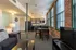 The pleasant living room creates a warm and comfortable atmosphere perfect for daily relaxation.  | Watch Factory Lofts | Apartment in,Waltham MA