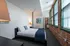 The airy bedroom provides bright, open atmosphere with natural light and comfortable proportions throughout.  | Watch Factory Lofts | Waltham Apartments
