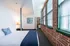 Bedroom with pillar and exposed brick wall at Watch Factory Lofts apartments in Waltham, MA.| Watch Factory Lofts | Watch Factory Lofts Apartments