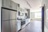 Stainless steel appliances and white-on-white cabinetry in the kitchen at The Chandler | The Chandler | Apartment in,Bedford NH