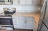 Close up showing details of the kitchen including appliances, cabinetry, and counter tops in the kitchen at an apartment at The Chandler | New Apartments in Bedford, NH.