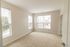 The James Apartments | Bright, empty bedroom with large windows, light-colored walls, and carpeted flooring, offering a spacious feel | Luxury Apartments in Haverhill MA
