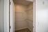 The James Apartments | Open closet with wire shelving in a bedroom with beige carpet and neutral-colored walls | Luxury Apartments in Haverhill MA