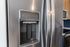 The James Apartments | Close-up of a stainless steel refrigerator with a built-in water and ice dispenser, featuring control settings | Luxury Apartments in Haverhill MA
