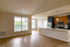 The James Apartments | Bright living space with vaulted ceiling, large windows, and an open-concept kitchen with a large island  | Luxury Apartments in Haverhill MA