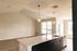 The James Apartments | Living space with vaulted ceiling, open-concept kitchen, and large windows offering natural light | Luxury Apartments in Haverhill MA