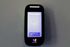 The James Apartments | Close-up of the ButterflyMX smart intercom system displaying a welcome screen with an option to tap and start | Luxury Apartments in Haverhill MA
