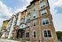 The James Apartments | Exterior view of a modern multi-story apartment building with stone accents and mixed siding, featuring large windows and balconies | Luxury Apartments in Haverhill MA