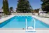 Dive into relaxation in our sparkling swimming pool surrounded by premium deck furniture and refreshing shade structures. | Foreside Estates | Foreside Estates Apartments