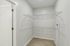 The James Apartments | Spacious, empty walk-in closet with wire shelving on beige carpet. | Luxury Apartments Haverhill MA