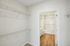 The James Apartments | Walk-in closet with wire shelving leading to a bathroom at 895 Boston Rd. | Luxury Apartments Haverhill MA