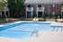 Dive into relaxation in our sparkling swimming pool surrounded by premium deck furniture and refreshing shade structures. | Princeton Green Apartments | Princeton Green Apartments