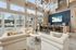 Chic lounge with modern furniture, large windows, and a stylish breakfast bar.