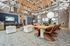 Spacious loft-style interior with modern furniture, natural lighting, and an open dining area.