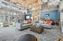Spacious and stylish lounge area with high ceilings, large windows, and modern furnishings.