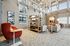 Bright, open lounge area with modern furniture and high ceilings.