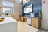 Sleek kitchenette with wooden cabinets, modern appliances, and stylish decor.