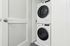 Modern laundry area featuring a sleek stacked washer and dryer combo set within a chic, minimalistic space.