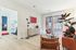 Bright and inviting living room featuring modern decor, a chic orange sofa, large windows with vertical blinds, and a stylish indoor plant for a fresh ambiance.