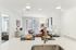 Modern open-plan living room with stylish furnishings, bright natural light, and a chic kitchen island, perfect for entertaining.