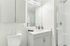 Sleek and modern bathroom with elegant white cabinetry, glass shower enclosure, and stylish fixtures, creating a bright and refreshing atmosphere.